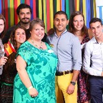 Seven people smiling holding the Spanish flag